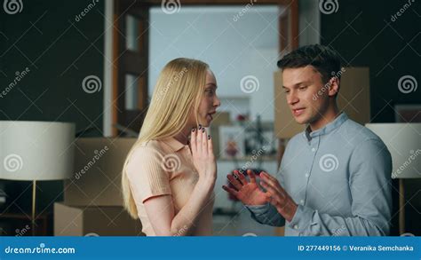 Millennial Couple Discussing Disagreement At Home Gesturing Emotionally