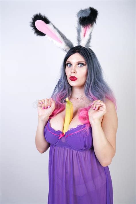 Erotic Banana And Donut In The Hands As A Symbol Of The Penis And Vagina Isolated On A White