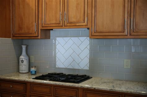 Light Blue Subway Tile Backsplash With White Herringbone Accetn