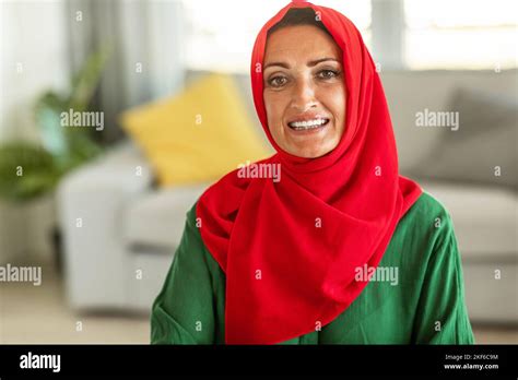 Portrait Of Positive Mature Muslim Woman Wearing Hijab And Smiling At
