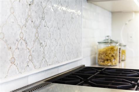 White Iridescent Arabesque Cooktop Tiles Layered On White Subway Tile