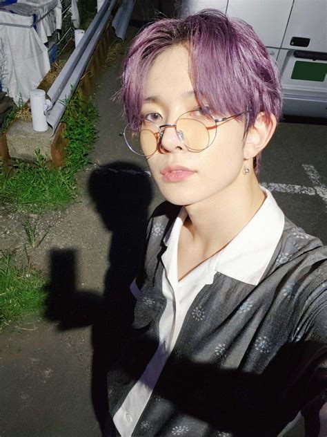 A Person With Purple Hair And Glasses On