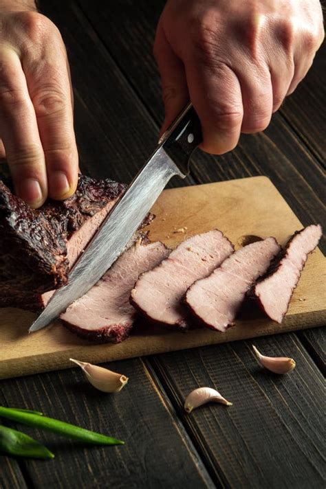 The Chef Cuts The Beef Baked Meat Before Preparing Dinner The Concept