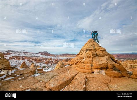 Hiker Scales Butte In Cottonwood Cove South Coyote Buttes Stock Photo