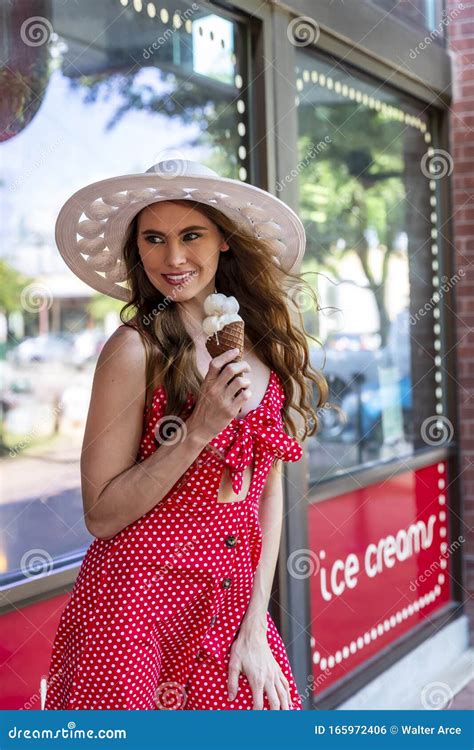 Lovely Brunette Model Eating Ice Cream While Posing Outdoors Stock Photo Image Of Cute