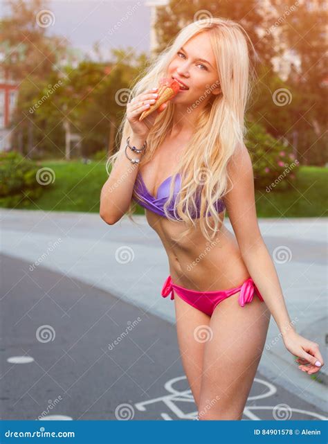Beautiful Blond Girl In Swimsuit Eating Ice Cream Summer Hot Day Solar Flare Portrait On A