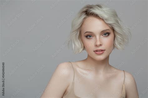 Portrait Of A Beautiful Blonde Girl With A Short Haircut Gray Background Stock Photo Adobe Stock