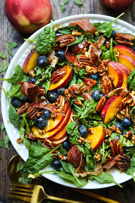 Peach Blueberry Spinach Salad With Prosciutto And Pecans In A Bowl