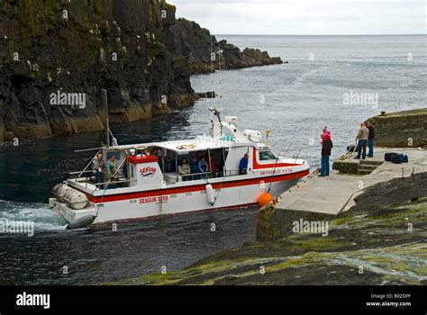 The passenger ferry arriving at Mykines Island, Faroe Islands Stock ...