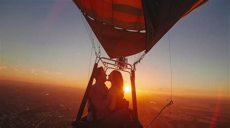 Hot Air Balloon Ride At Sunset A Couple Is Kissing In A Hot Air Balloon The Sun Is Setting