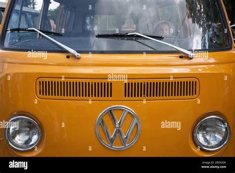 A Boy Seen Playing In An Old Volkswagen Minibus During A Festival Of