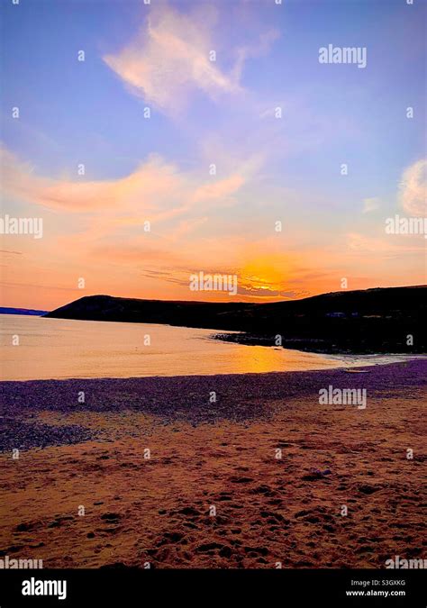 Sunset over manorbier beach Stock Photo - Alamy