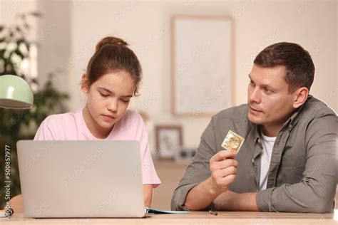 Father Talking With His Teenage Daughter About Contraception While She Using Laptop At Home Sex