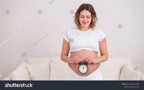 Pregnant Woman Naked Belly Holds Alarm Stock Photo 2228437667 Shutterstock