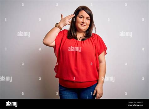 Beautiful Brunette Plus Size Woman Wearing Casual Red T Shirt Over Isolated White Background