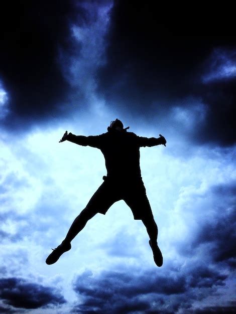 Premium Photo Low Angle View Of Silhouette Man Jumping Against Sky