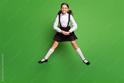 Photo Portrait Of Brunette Schoolgirl With Pigtails Jumping Up With Spread Legs Hands Together