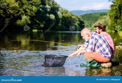Retired Father And Mature Bearded Son Two Male Friends Fishing