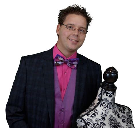 A Man In A Suit And Bow Tie Standing Next To A Dress Mannequin