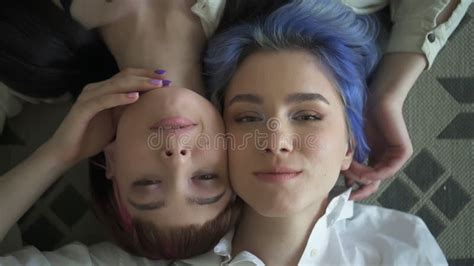 Happy Lesbian Women Are Kissing And Touching While Sitting On Sofa In Home Interior Spbd Stock