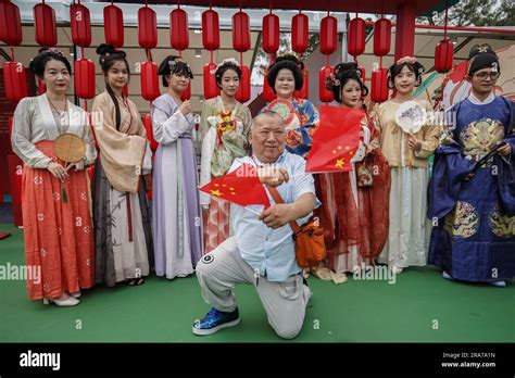 A Man Waves Two Flags Of China In A Handover Celebration At Victoria