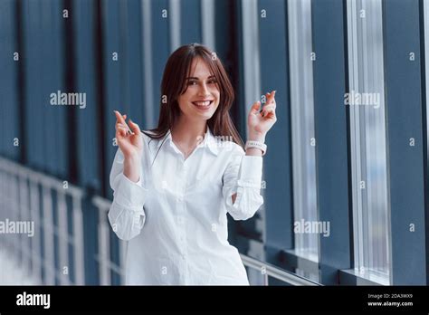 Brunette In White Shirt Posing Indoors In Modern Airport Or Hallway At Daytime Stock Photo Alamy
