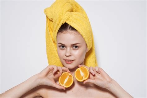 Premium Photo Cheerful Woman Naked Shoulders Oranges In The Hands Of A Yellow Towel On Her