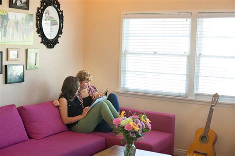 Caucasian Lesbian Couple Reading Book On License Image Lookphotos