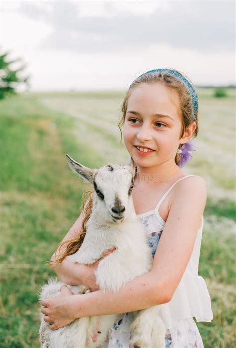 Girl With Baby Goat On Farm Outdoors Love And Care Village Animals