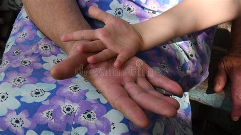 Closeup Great Grandchild Hand Atop Hand Palm Of Great Grandmother Stock