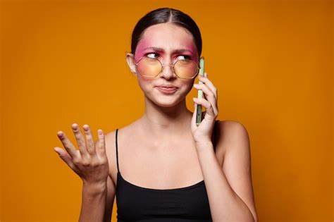 Premium Photo Sexy Brunette Woman With Phone Pink Face Makeup Posing Attractive Look Glasses