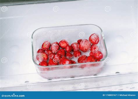 Frozen Strawberries In A Container In The Freezer Stock Image Image