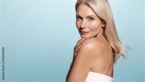 Mature Old Lady With Beautiful Glowing Body And Face Looks Behind Her Shoulder With Confident