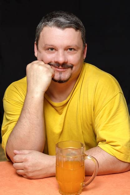 Premium Photo Dark Smiling Man Holding A Glass Of Beer