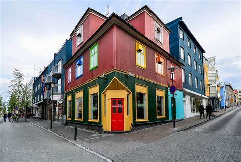 The Colorful Building Has Many Windows On It