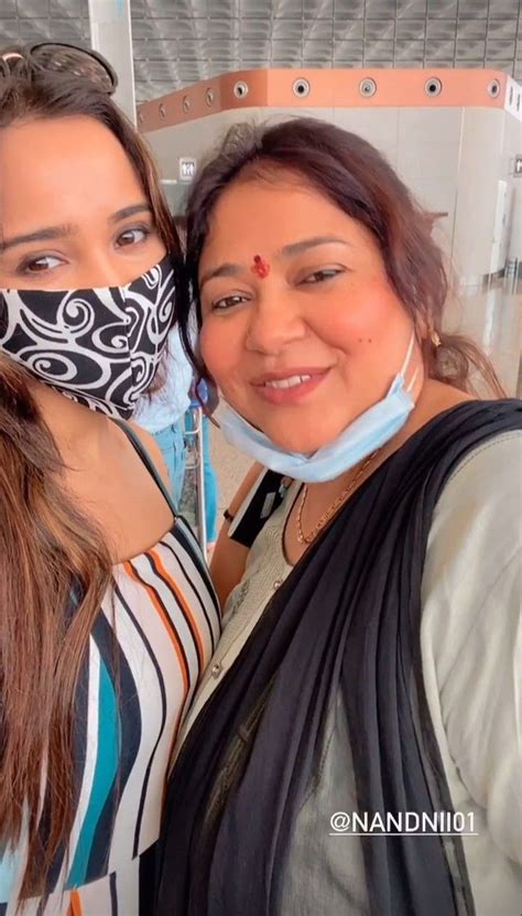 Two Women With Masks On Their Faces Posing For The Camera