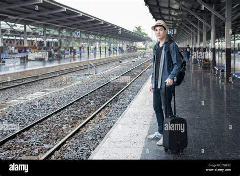 Asian Young Man Waiting Train For Journey At Station Stock Photo Alamy