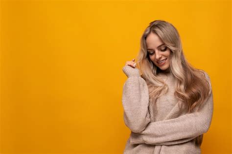 Premium Photo Photo Of Shy Blonde Girl On Yellow Background