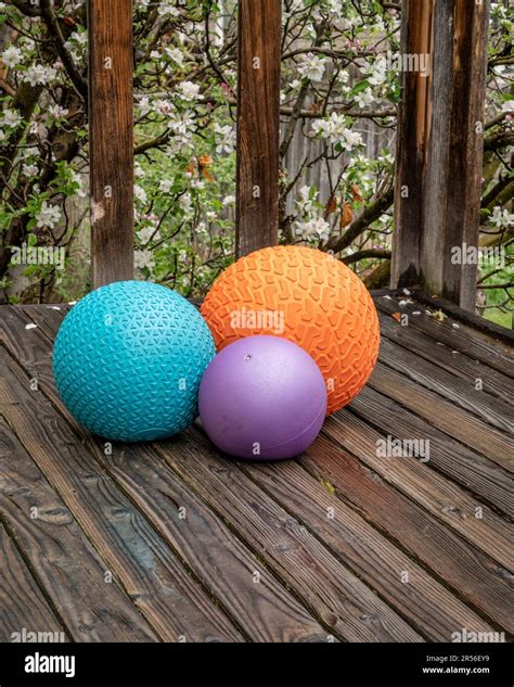 heavy slam balls filled with sand on a backyard deck, exercise and