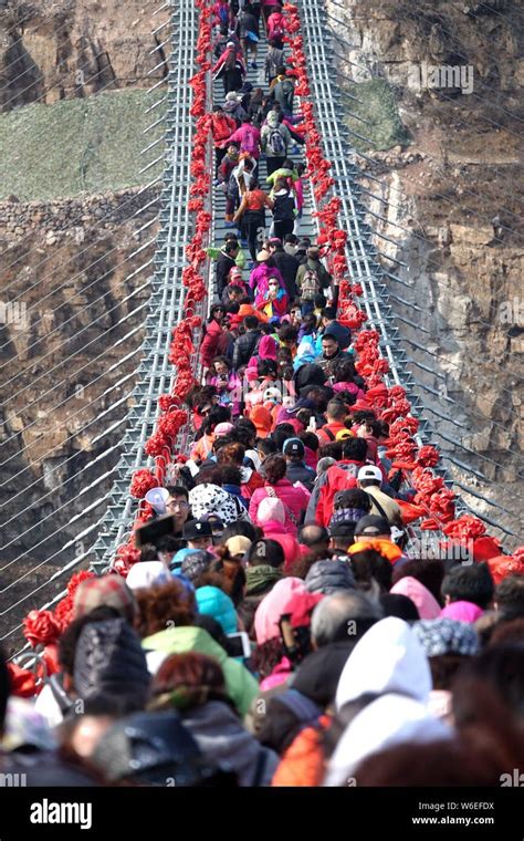 Tourists throng to walk on the world's longest glass bridge in the ...