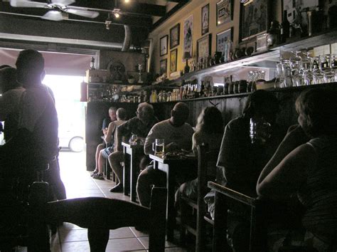 patrons enjoying drinks   dimly lit bar  stock photo freeimages