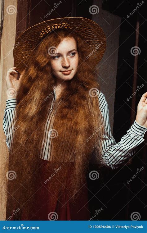 Lovely Young Red Haired Model With Freckles In Straw Hat Posing Stock