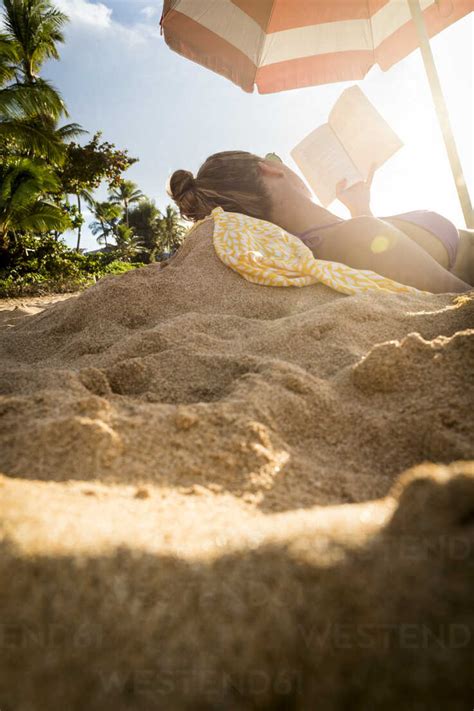 Woman In Bikini Reading Book On Beach Oahu Hawaii Usa Stock Photo