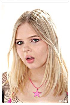 A Woman With Long Blonde Hair Wearing A Pink Star Necklace
