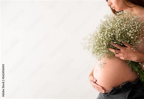 Cropped Shot Of Unrecognizable Naked Pregnant Woman Hiding Breast With Big Gypsophila Flower