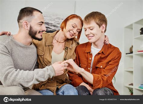 Overjoyed Woman Closed Eyes Embracing Son Gay Partner Home Stock
