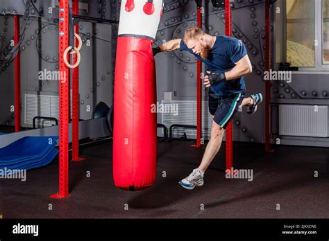Young mixed martial arts fighter in high jump delivers strong straight ...