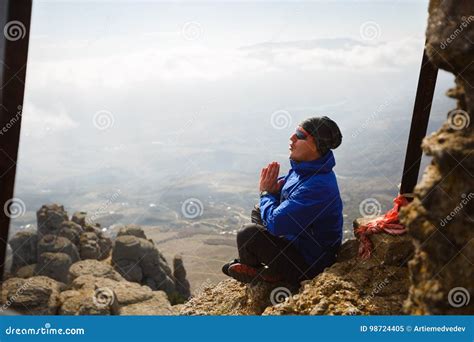 Man Meditating On A Mountain Peak Rock Hiker Doing Yoga Stock Image