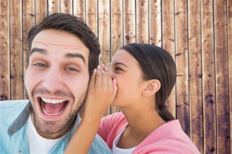 Premium Photo Brunette Whispering Secret To Her Boyfriend Against Wooden Planks Background