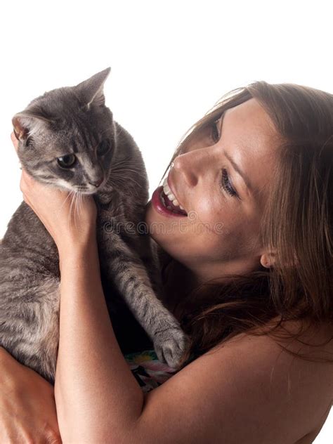 Smiling Beautiful Brunette Holding And Petting Her Cute Grey Cat Stock